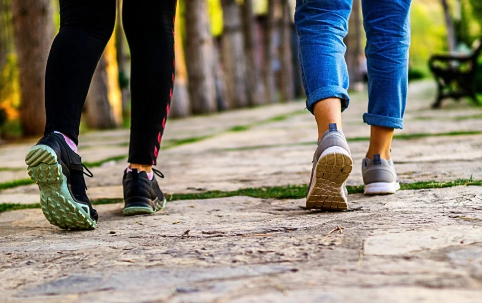 Two people walking along the KK following the Walkable Kota Kinabalu city guide