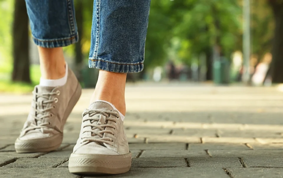 A woman walking around Kota Kinabalu city, highlighting how convenient it is to explore the area while staying at Polaris Suite.