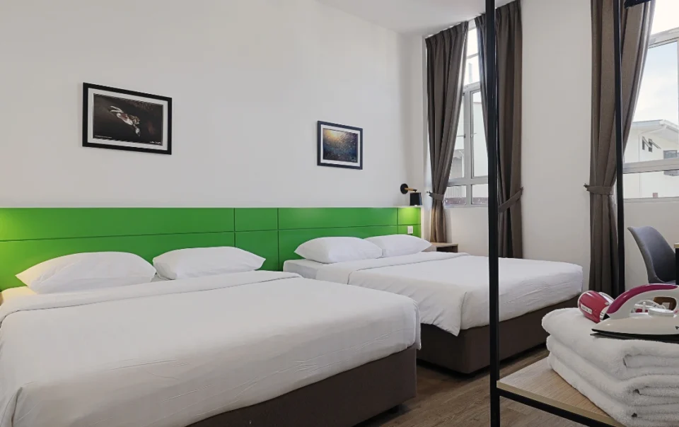 Interior view of Polaris Suite Deluxe Apartment Type A showing spacious bedrooms, each furnished with two queen beds