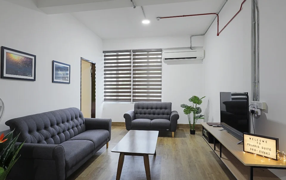 Spacious living room area of the Polaris Suite Deluxe Apartment Type A featuring comfortable seating and a modern apartment-style interior.