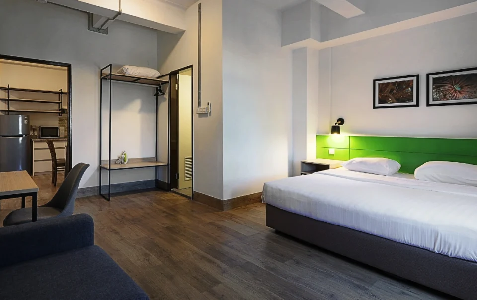 Bedroom inside Polaris Suite Deluxe Apartment Type B featuring one queen bed and an additional sofa bed