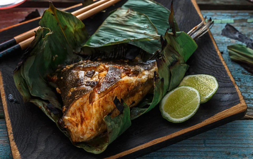 Grilled stingray served on a plate, a popular seafood dish at the Filipino Market in Kota Kinabalu